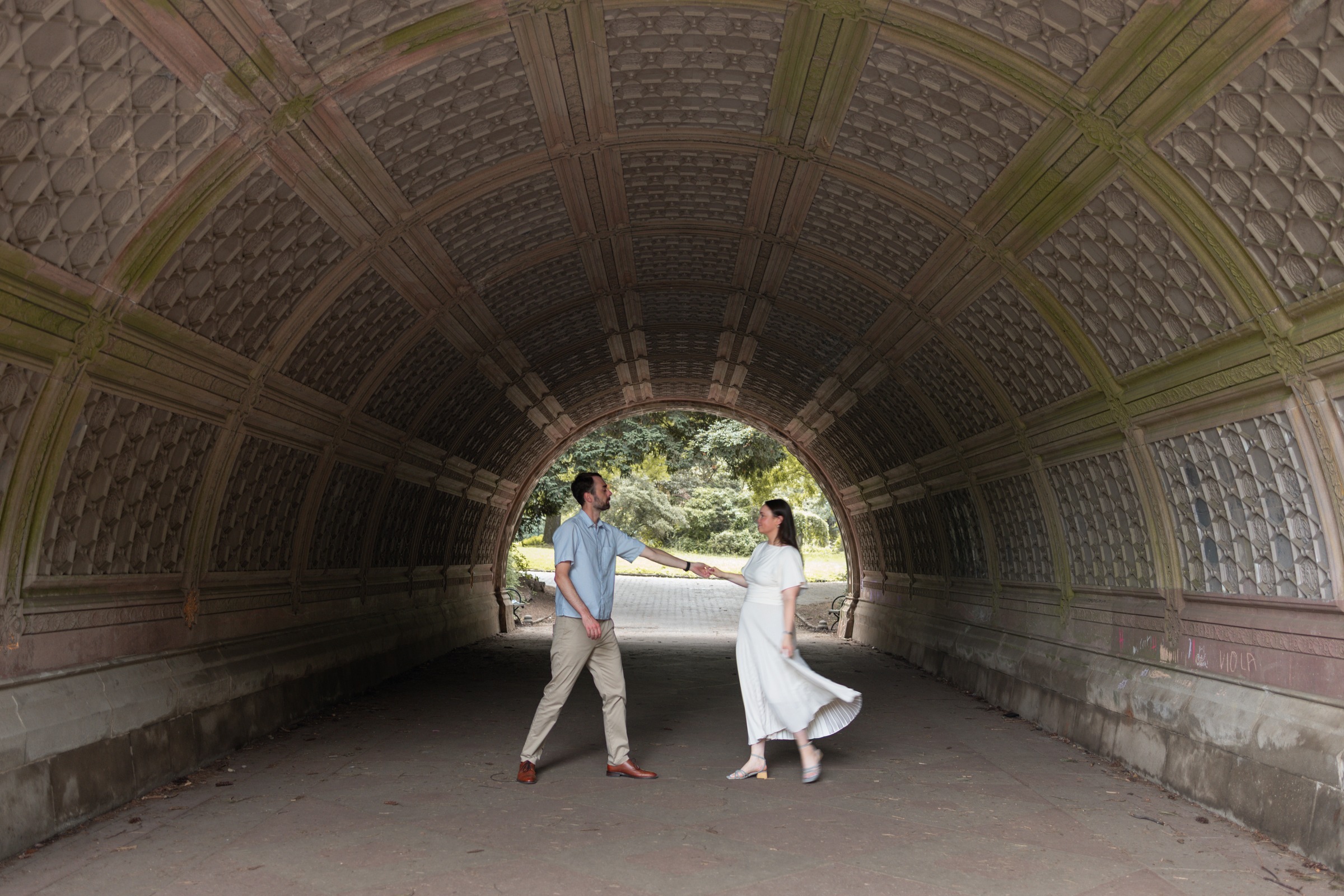 Monika and Haggai twirling under the vaulted brick arch of the Prospect Park underpass.